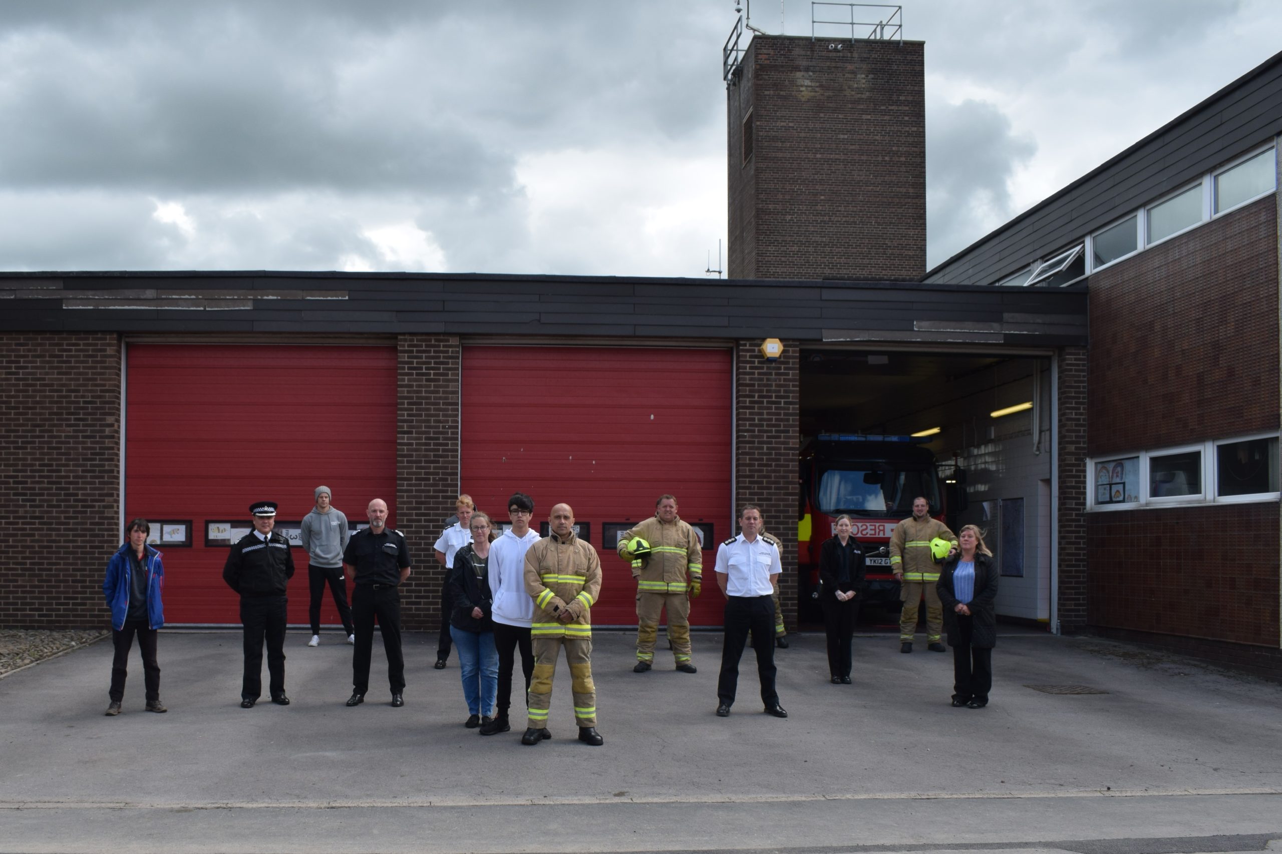 Standing Up to Racism people gathered in front of fire station